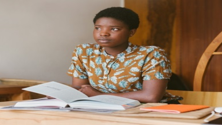 Young Girl with open book on desk